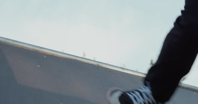 Young adult skateboarding halfpipe 4k super slow motion