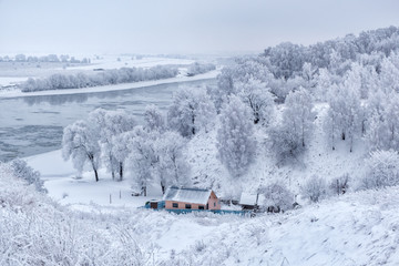 Beautiful winter landscape. wide river with snow-covered silvery trees on the banks
