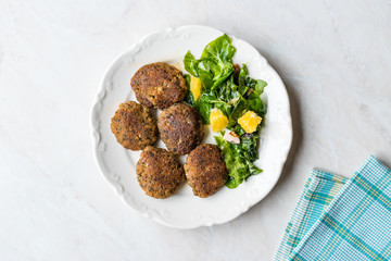 Homemade Salmon Meatballs Served with Orange Salad.