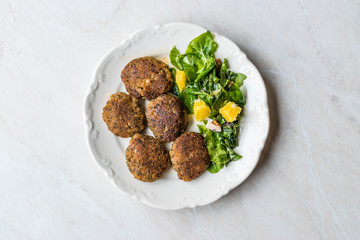 Homemade Salmon Meatballs Served with Orange Salad.