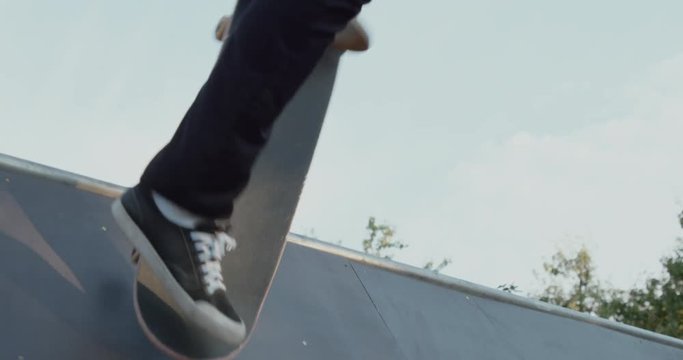 Young adult fails skateboarding halfpipe 4k super slow motion