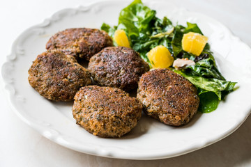 Homemade Salmon Meatballs Served with Orange Salad.