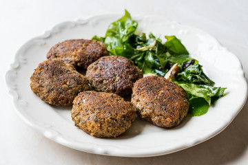 Homemade Salmon Meatballs Served with Orange Salad.