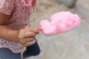 body parts. girl holding pink cotton candy