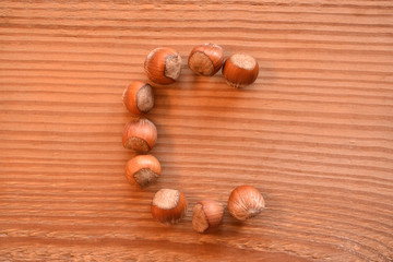 the letter C made with hazelnuts