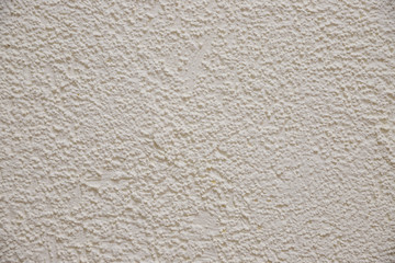 Texture of the old plastered beige color cement wall, Surface emboss sharp and rough pattern of concrete wallpaper background.beige embossed background. concrete wall
