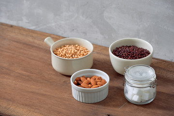 Varieties of nuts: soy nuts, hazelnuts and red beans with sugar in glass jar. Food and cuisine.