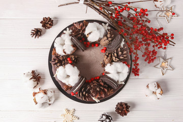 Christmas  cake with flowers and chocolate. Wedding details - wedding cake.  Winter cake with cones