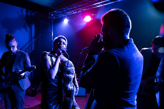 Musicians perform on stage in the club.