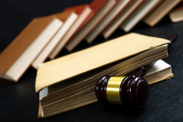 Judge gavel beside pile of books