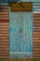 The door is made of old wood.