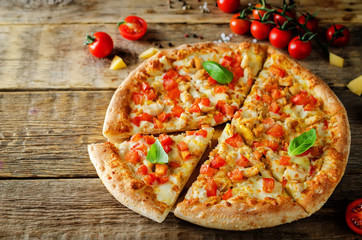 Pizza with cheese, chicken and fresh tomato slices