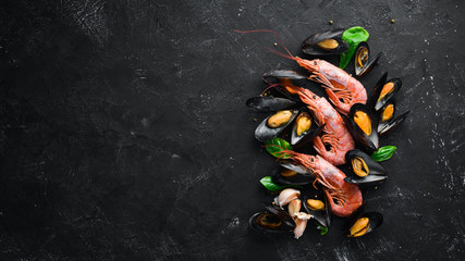 Cooked mussels and shrimp. Top view. Free space for your text. On the old background.