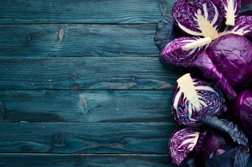 Purple cabbage on a blue wooden background. Organic food. Top view. Free space for your text.