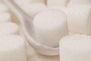 Fototapeta na wymiar closeup of sugar in shaped circle in white spoon