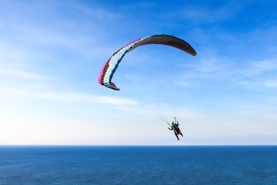 Parachute on sky and sea background