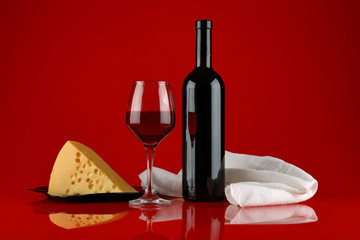 Still life with red wine, cheese and white towel