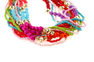 Colorful string of beads isolated on white background - closeup