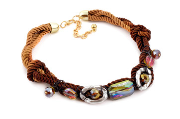 Modern fashion necklace made of cords and rhinestones isolated on white background