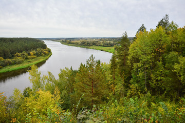 Autumn landscape on cool, cloudy day. Panoramic view of the forest and Neman river.