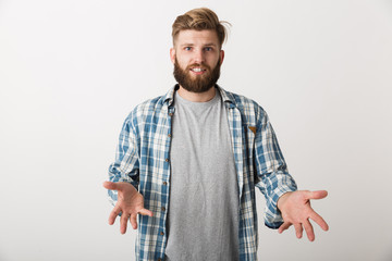 Confused young man dressed in plaid shirt s