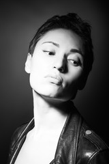 portrait of beautiful sensual woman looking down on dark background 