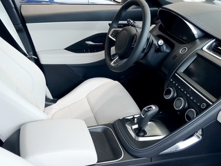 Combination of black and white leather upholstery in car interior 