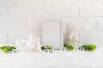 Christmas home decoration with white frame and christmas tree branches, deer and lights on white background. Mock-up