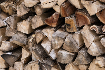 chopped firewood folded. for background. wood texture. alternative type of fuel.