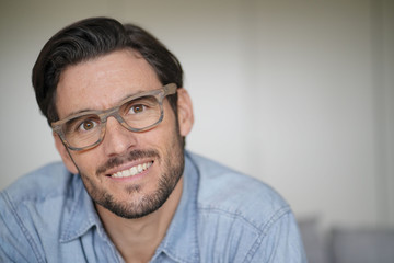 Portrait of casual handsome man wearing designer glasses