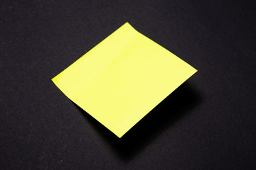 Yellowl sticky notes on black background