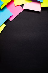 Many colorful sticky notes on black background