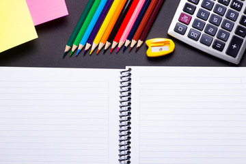 School and office suplies on black background