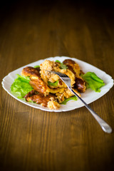 fried omelet with meat and greens in a plate