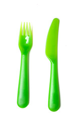 set of green baby plastic fork and knife on white background