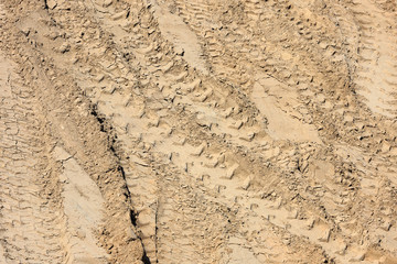Traces of tire treads on the sand.