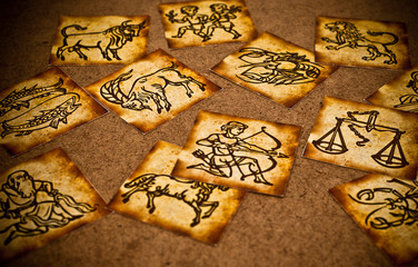 zodiac signs lying on horoscope like astrology esoteric concept