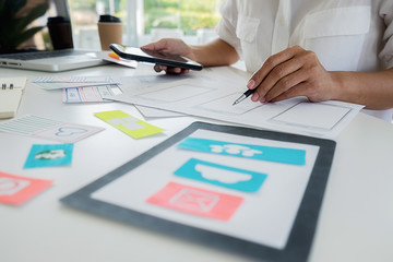 Creative Web Designer planning application and developing template layout, framework for mobile phone. User experience (UX) concept.