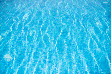 Blue swimming pool rippled water detail. Background
