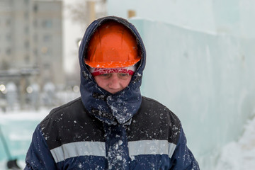 Fototapeta na wymiar Portrait of an assembler in an orange helmet