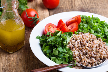 Healthy cooked buckwheat grain salad with fresh vegetables