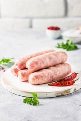 Raw sausages with spices, herbs. Selective focus, space for text.