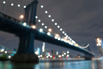 Blurry view of The Brooklyn Bridge in New York at night for backgrounds.