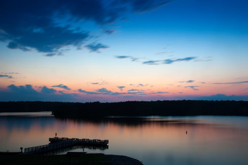 Fototapeta na wymiar Reflection of the sky in a lake at dusk.
