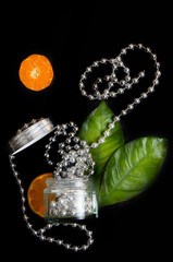 abstract composition with cosmetics, citrus, seashell and beads