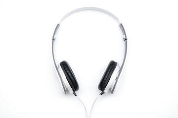 Obraz premium Lie white headphones on a white background.