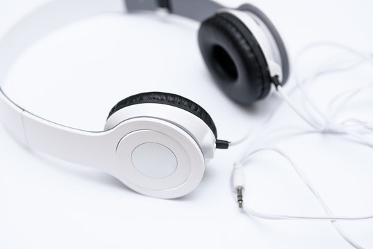 Lie white headphones on a white background.