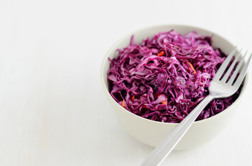 Fork on bowl with purple sauerkraut