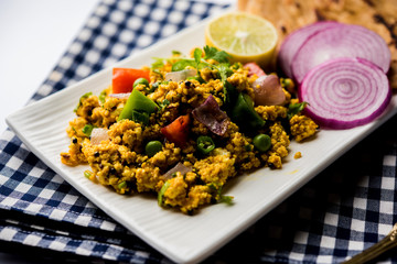 Paneer Bhurji, mildly spiced cottage cheese scramble and served with roti or laccha paratha, selective focus