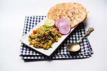 Paneer Bhurji, mildly spiced cottage cheese scramble and served with roti or laccha paratha, selective focus